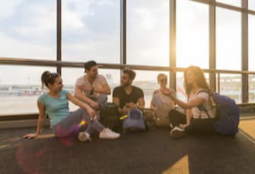 a group of friends sitting in an airport